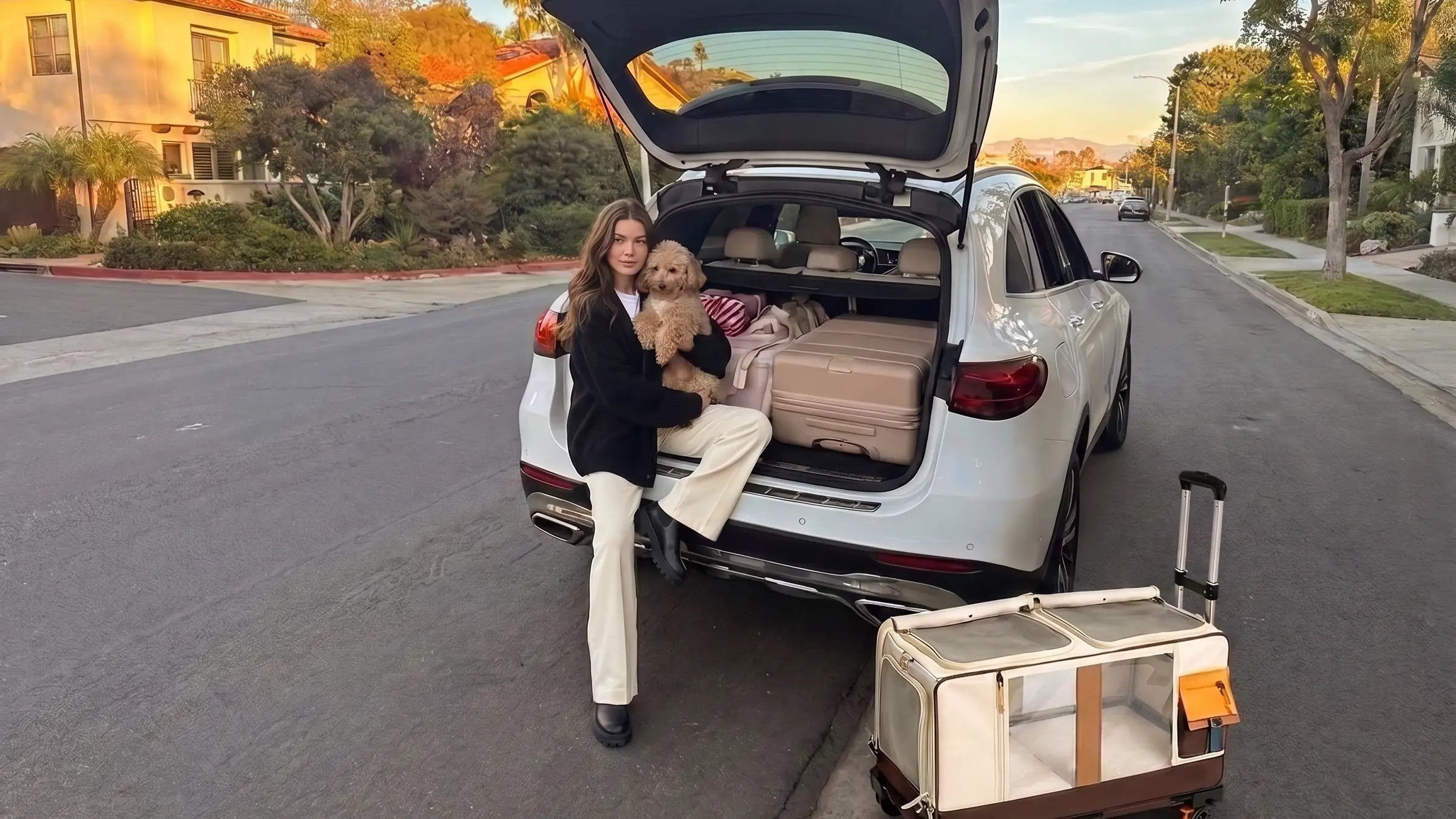 women and small dog taking a break beside a travel carrier on road
