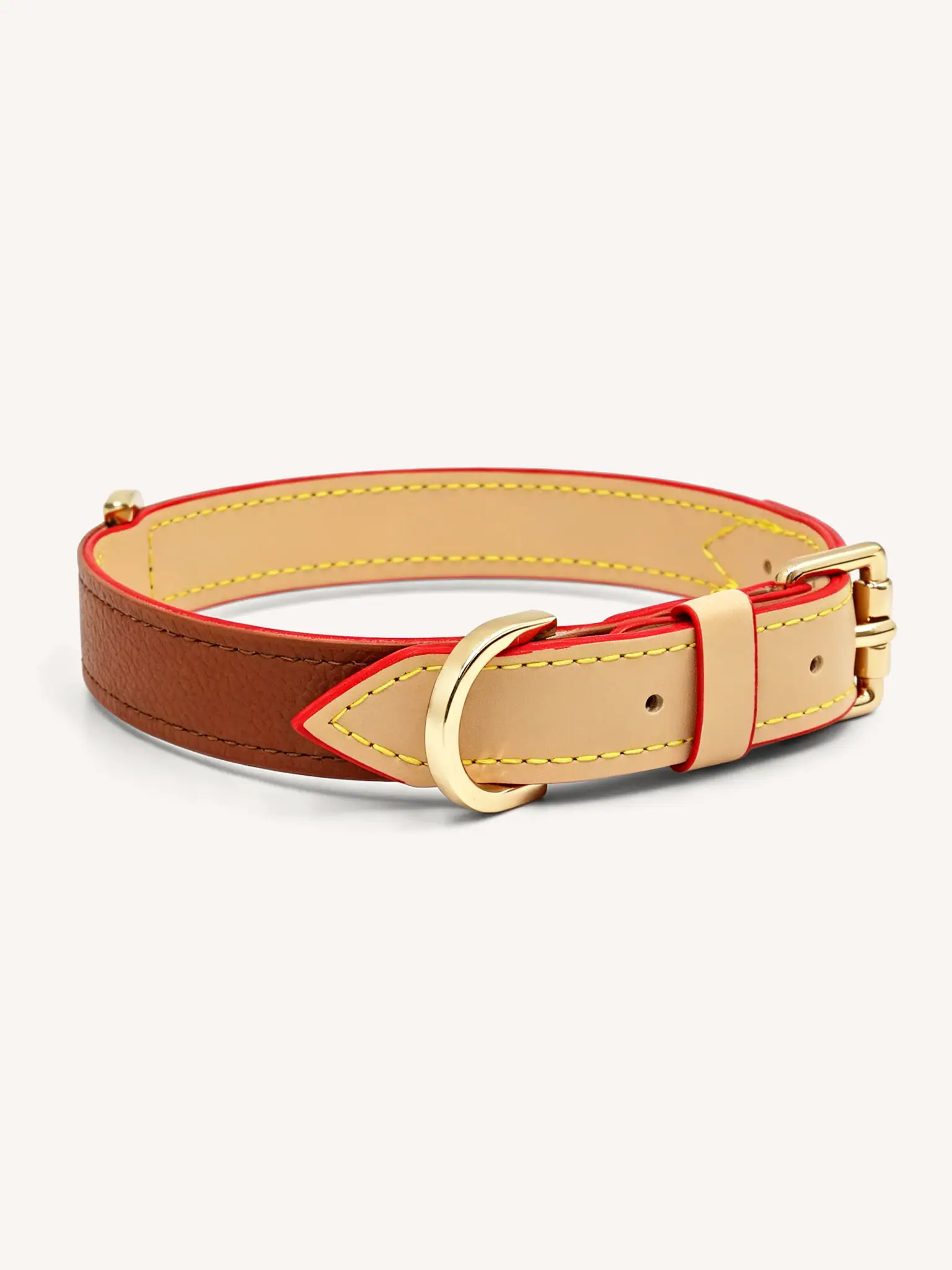 The brown leather collar was lying flat on the ground