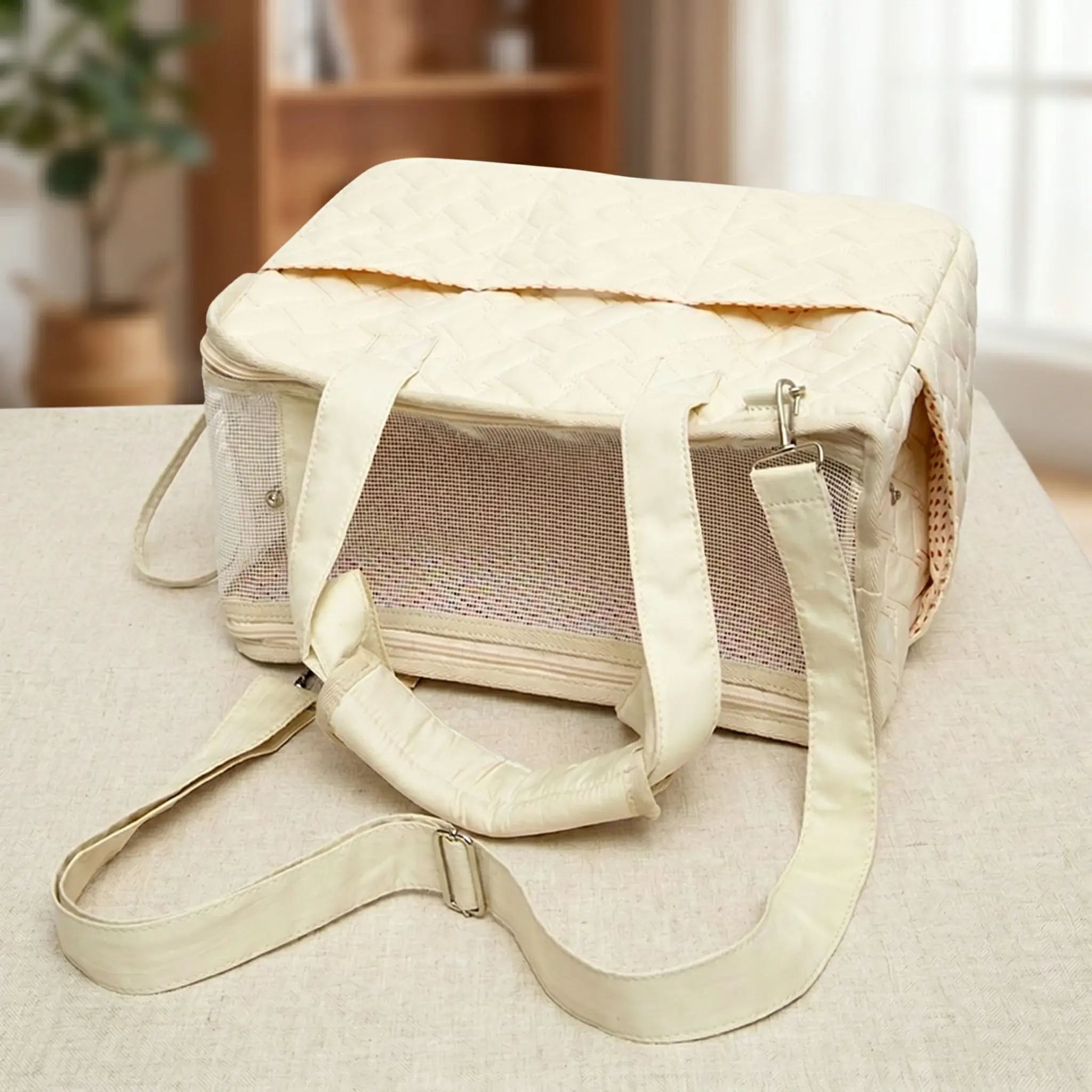 A beige tote bag is placed horizontally on tabletop, featuring a top mesh design