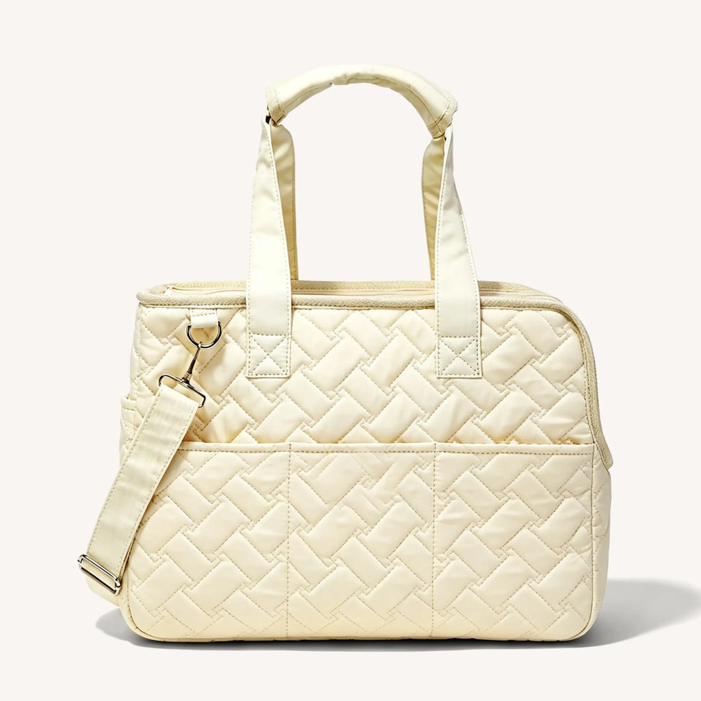 Side view of the beige pet tote bag, featuring a shoulder strap