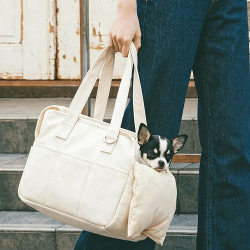 Beige pet tote bag, with a sleeping Chihuahua inside