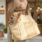 women holding small dog carrier with a dog in it