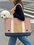 The woman carried the Bichon Frise dog in a striped tote bag